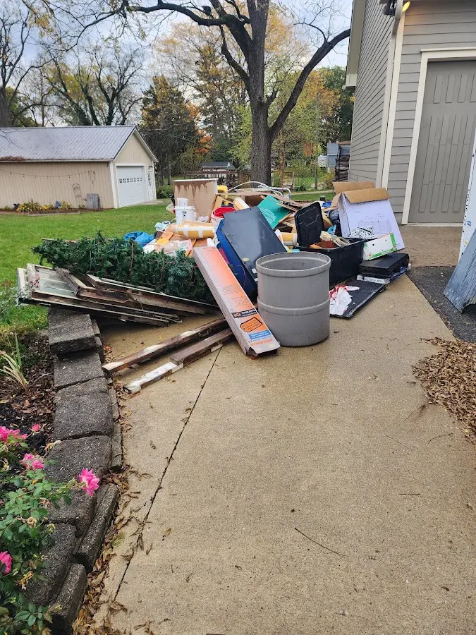 Dumpster being loaded with debris for Estate Cleanout Dumpster Rental in Jenks